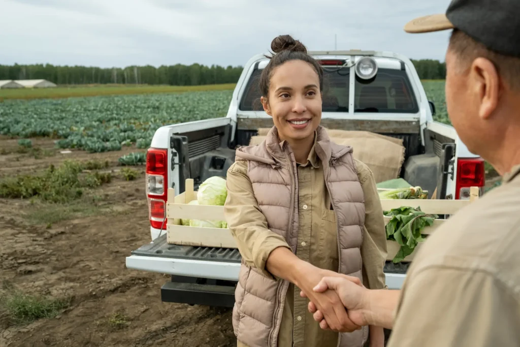 happy businesswoman shaking hand of mature farmer 2025 03 31 14 16 05 utc